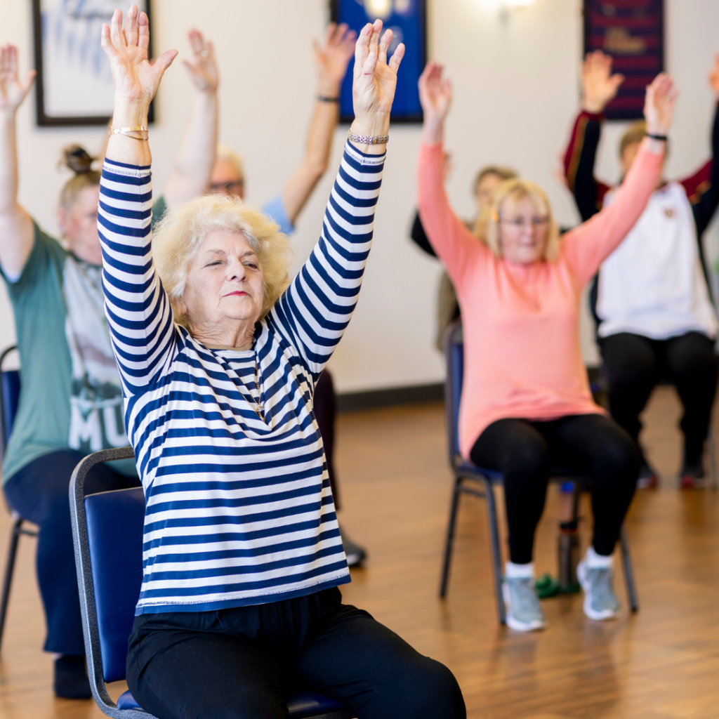Seniors doing a seated exercise | Comfort Keepers Calgary | BLOG POST | Low Impact Exercises