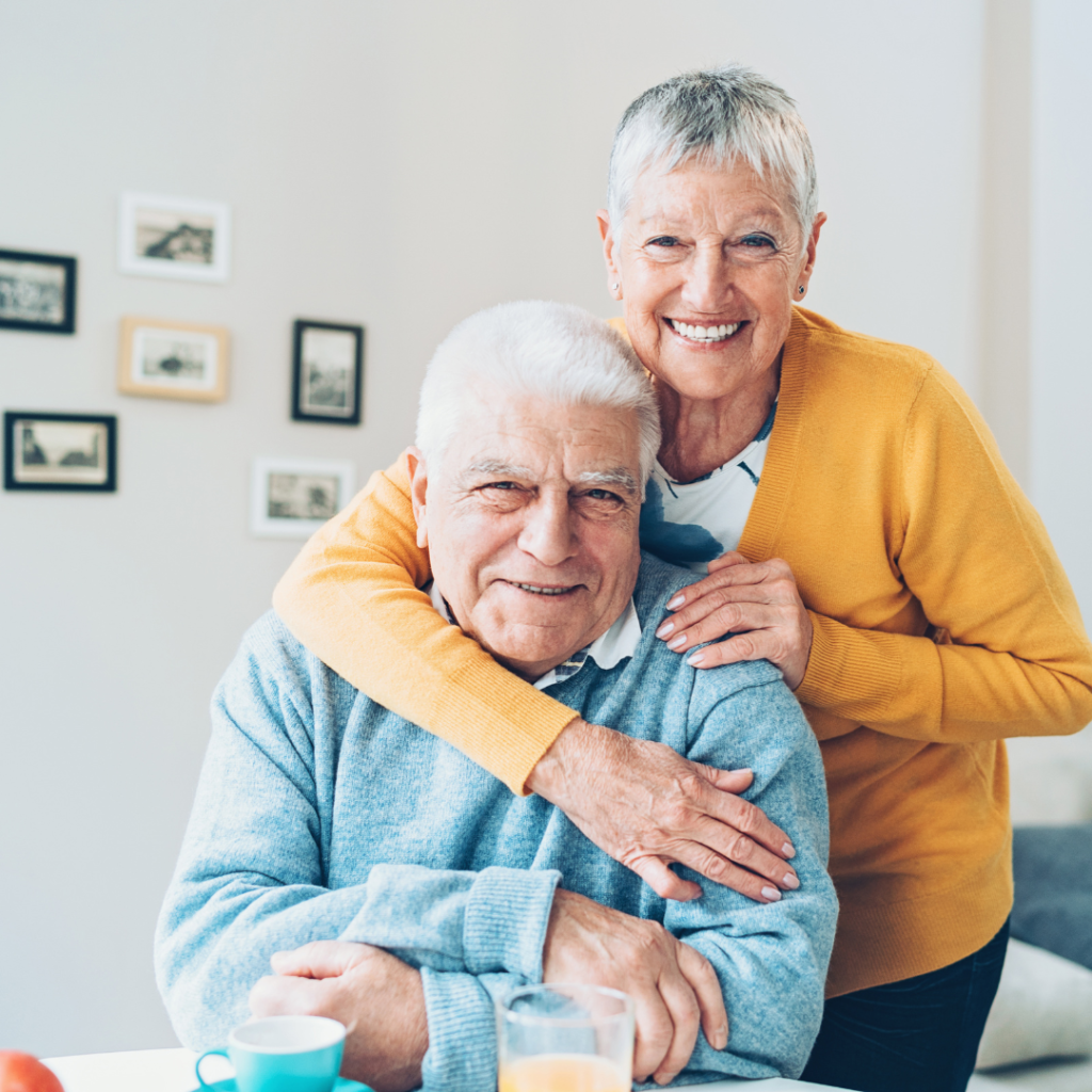 Two seniors embraced and smiling at camera | Comfort Keepers Calgary | BLOG POST | Memory Problems in Seniors