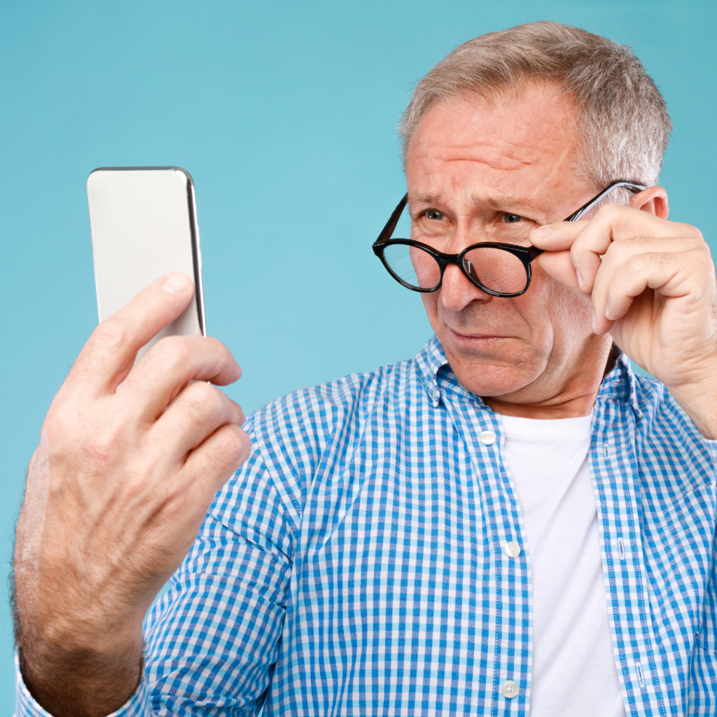 Senior male struggling to read his phone | Comfort Keepers Calgary | BLOG POST | Vision Loss in Seniors