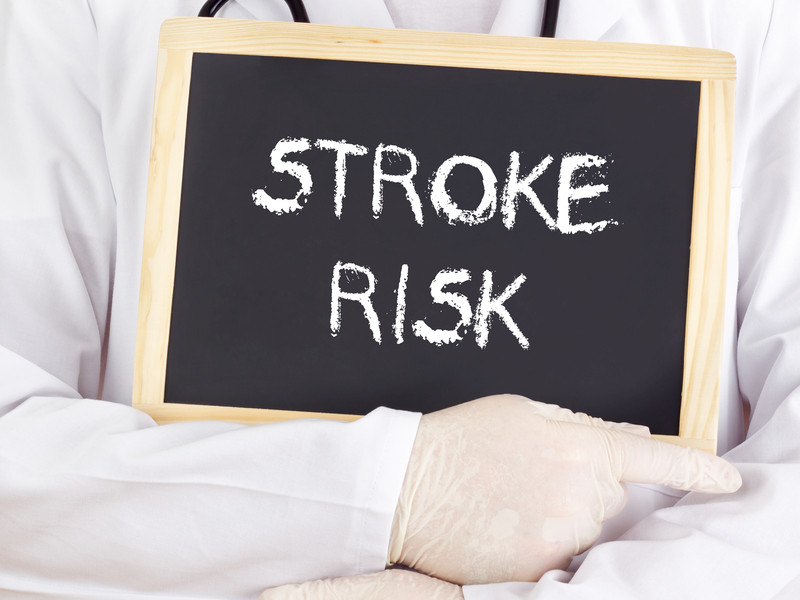 Person holding chalkbaord that reads: STROKE RISK | Comfort Keepers Calgary | BLOG POST | Recognizing Symptoms of Stroke