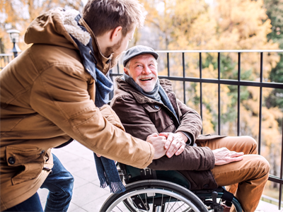 Senior Male seated in wheelchair with friend | Comfort Keepers Calgary | BLOG POST | Ensure Your Senior's Safety During the Colder Months