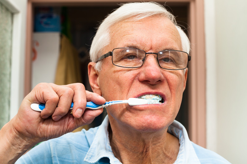 Senior Male brushing teeth | Comfort Keepers Calgary | BLOG POST | Seniors and Oral Cancer & Hygiene