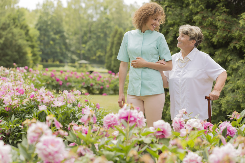 Senior Woman walking with Caregiver | Comfort Keepers Calgary | BLOG POST | Managing Stress in Seniors