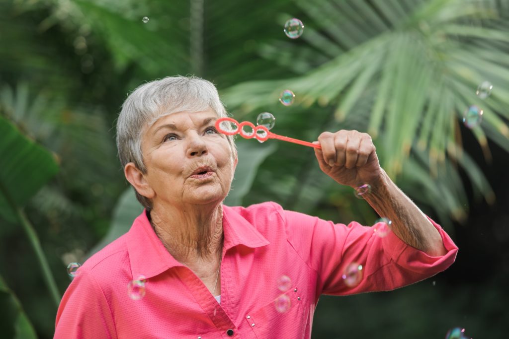Senior Woman blowing bubbles outside | Comfort Keepers Calgary | BLOG POST | Healthy Aging