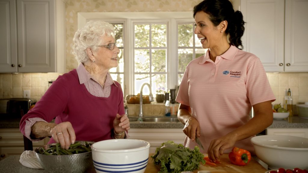 Senior woman baking with caregiver | Comfort Keepers Calgary | BLOG POST | The Benefits of In Home Care for Seniors