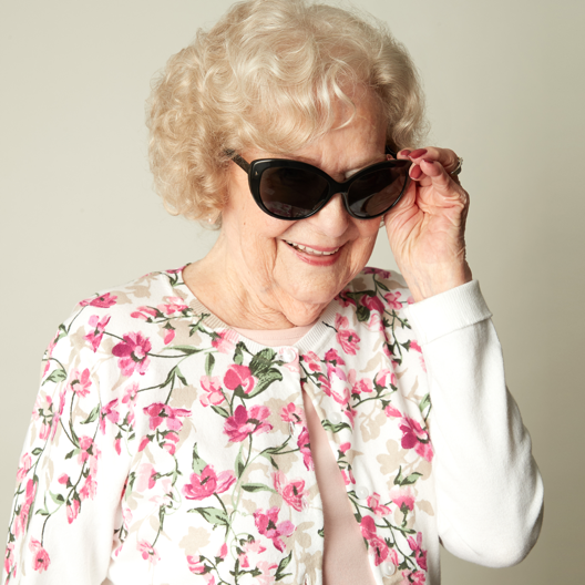Senior woman smiling and wearing sunglasses | Comfort Keepers Calgary | How to Notice Vision Loss in Seniors | BLOG POST