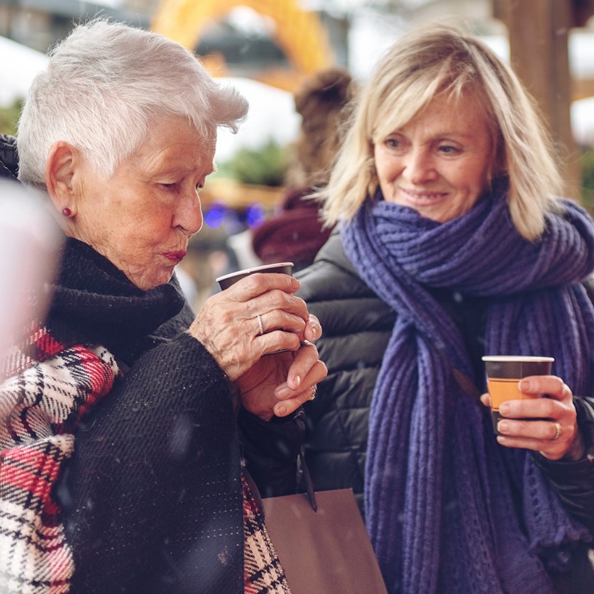 Two seniors outside sipping a hot beverage | Comfort Keepers Calgary | BLOG POST | Is It Time For In Home Care?