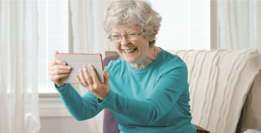 Senior women smiling and motioning in a welcoming manner | Comfort Keepers Calgary | BLOG POST | Stress Relief Tips for Seniors