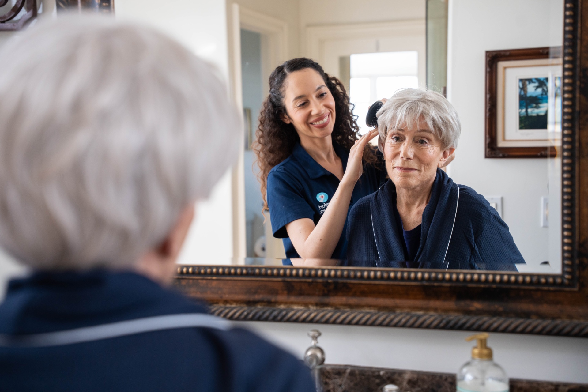 Comfort Keepers Calgary caregivers with client fixing hair