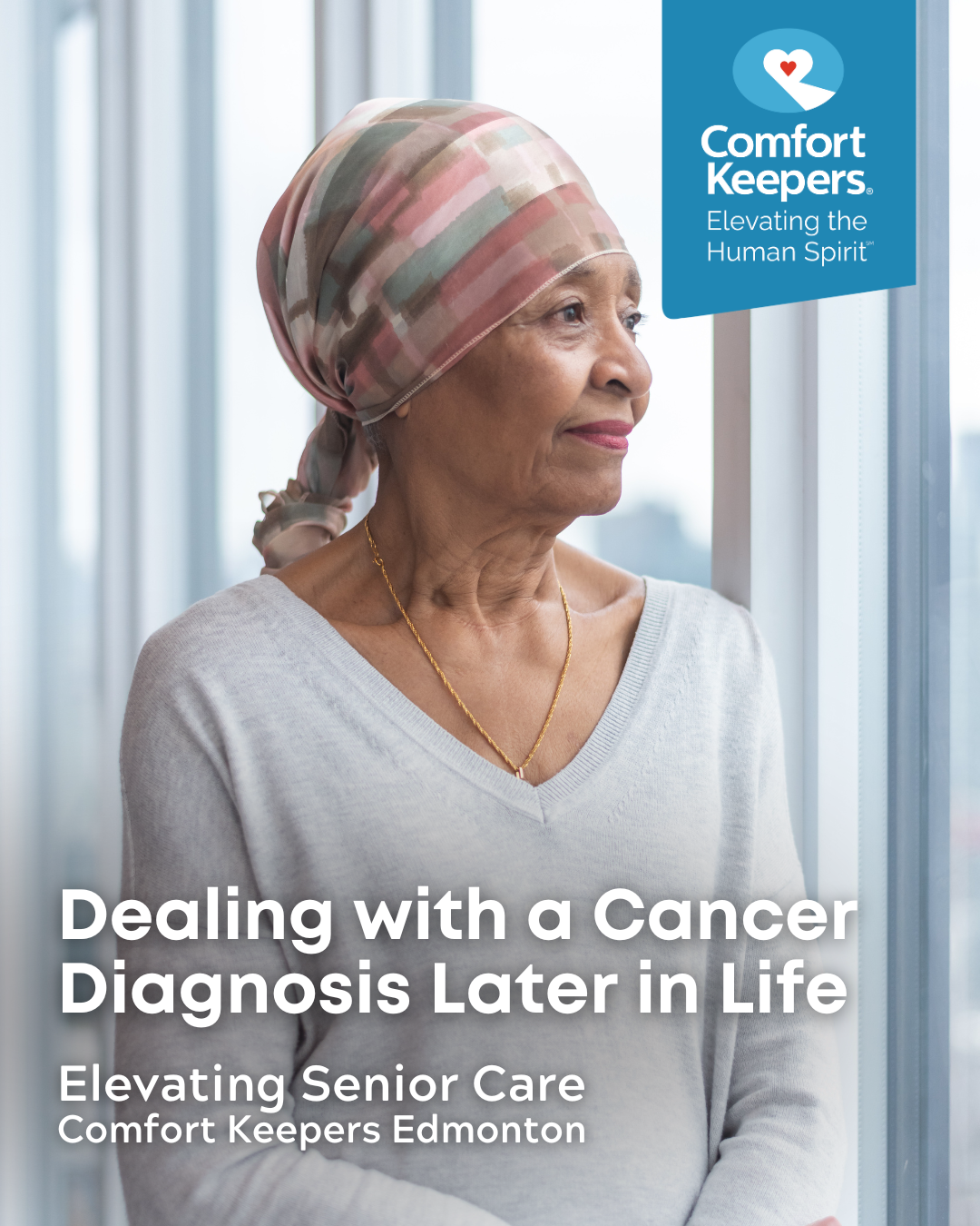 Senior woman with headwrap looking out window | Dealing with a Cancer Diagnosis Later in Life | Comfort Keepers Edmonton | BLOG POST