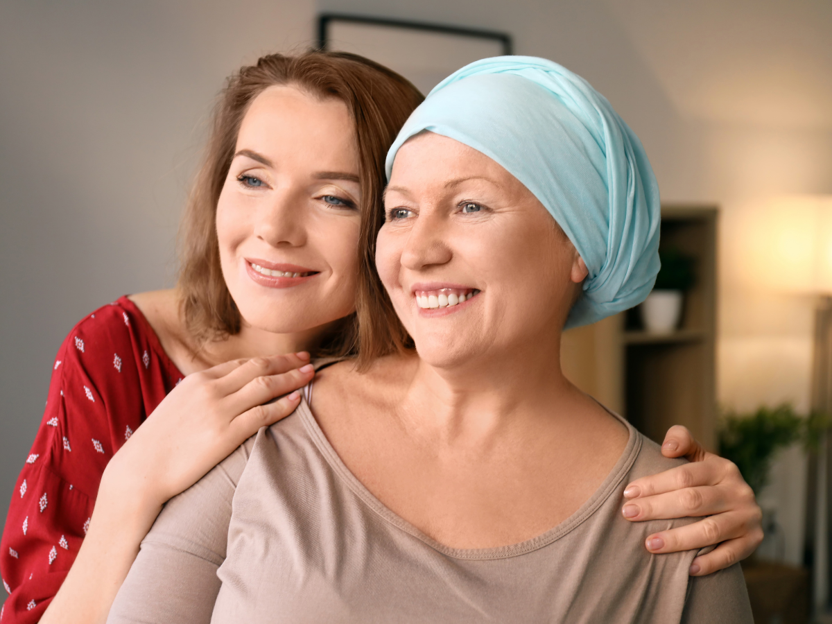 Senior woman with cancer being hugged by friend | Dealing with a Late-in-Life Cancer Diagnosis | Comfort Keepers Edmonton
