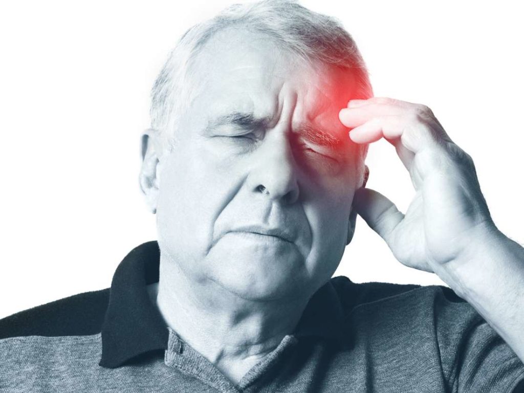 Senior male holding hand to forehead seemingly with head pain | Facts About Strokes | Comfort Keepers Edmonton | BLOG POST