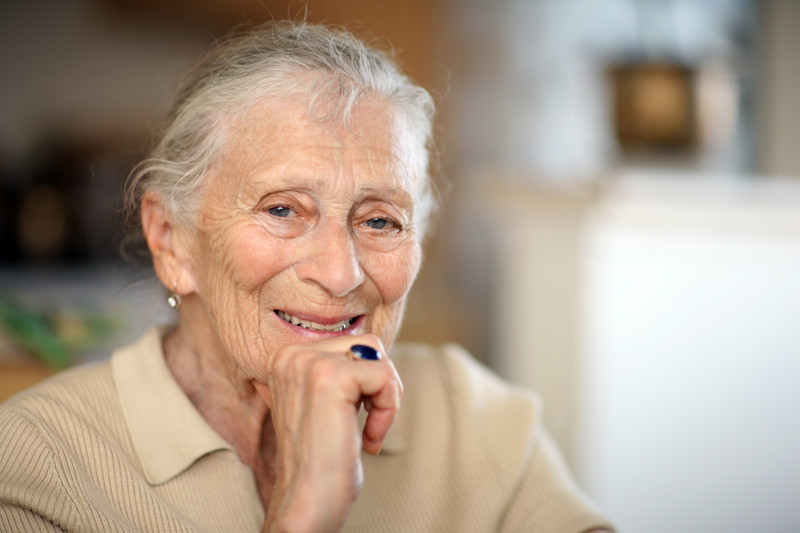 Senior Woman smiling at camera | Helping Seniors Who Suffer from Alzheimer’s | Comfort Keepers Edmonton | BLOG POST