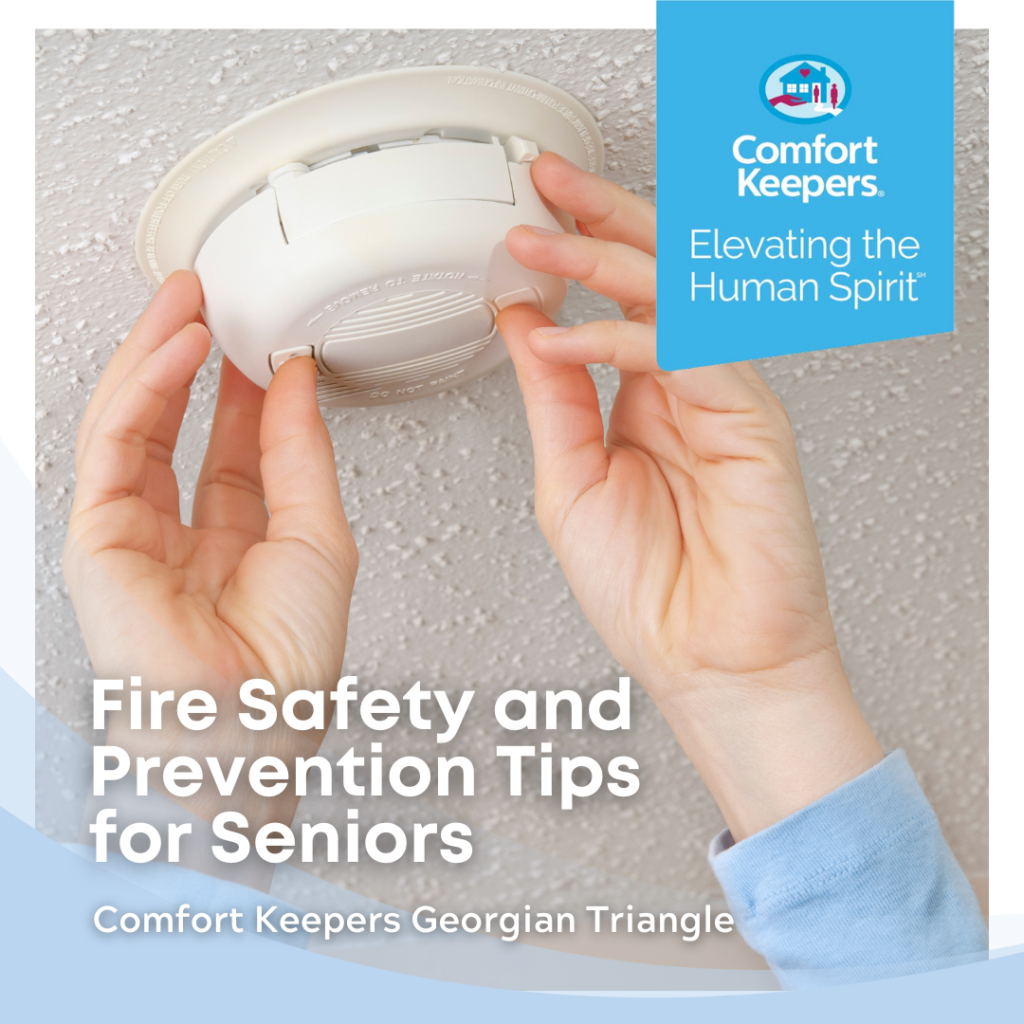 Someone is adjusting s smoke detector | Comfort Keepers Georgian Triangle | BLOG POST | Fire Safety and Prevention Tips for Seniors