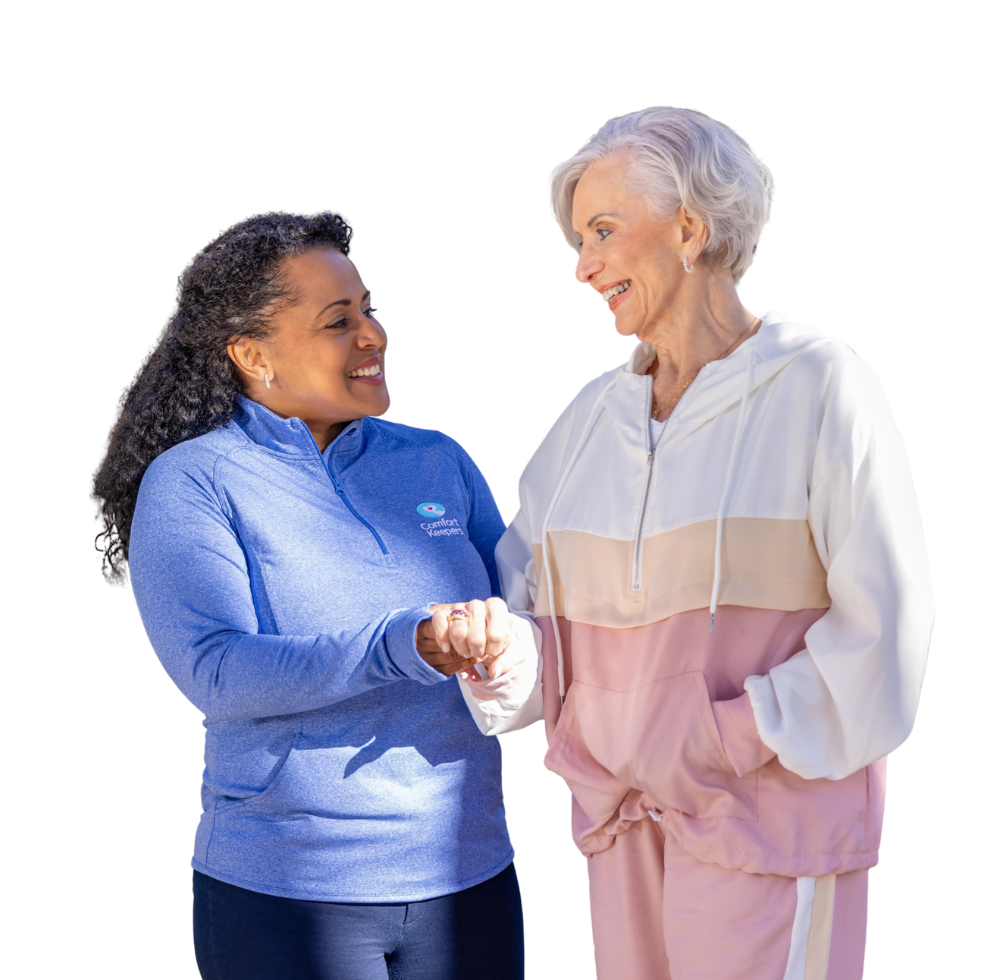 Comfort Keepers caregiver and client holding hands.