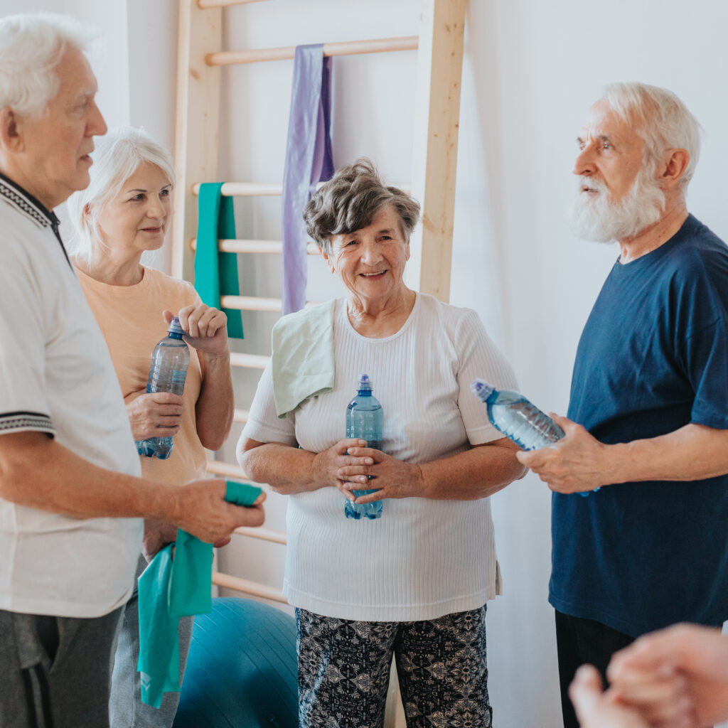 Group of older adults holding water bottles after exercise – in home senior care Guelph