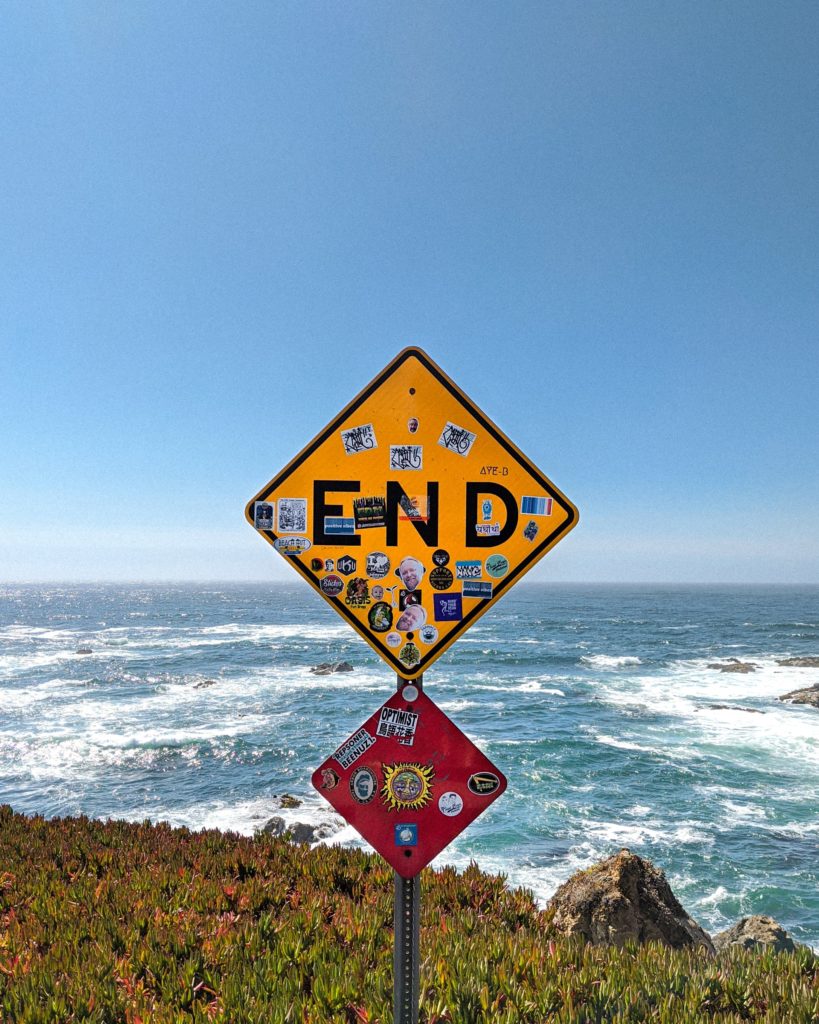 A road sign stating "the end" overlooking a seaside cliff; this is maybe the final challenge of retirement