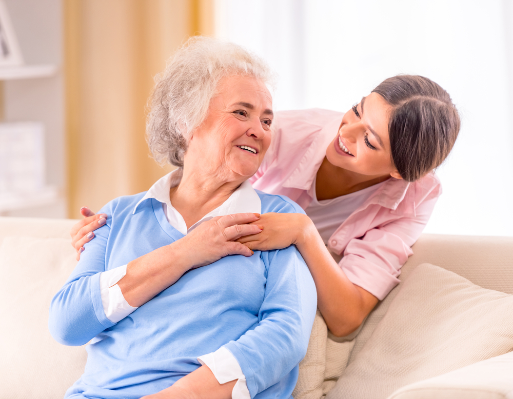 Young woman caring for elderly grandparent | How to Care for A Loved One with Restricted Mobility