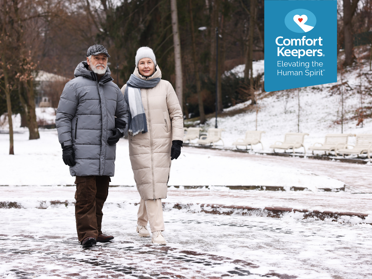 A senior couple walks outdoors during winter | Winter Health Risks for Seniors Living in British Columbia | Comfort Keepers North and West Vancouver