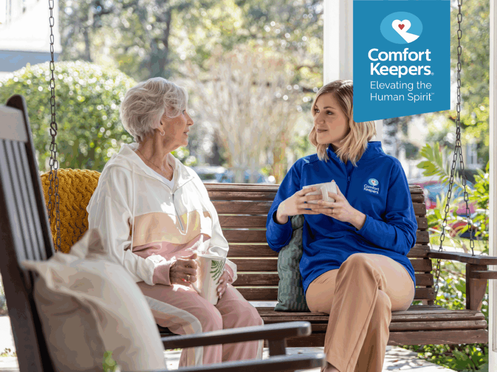 A senior sit on her porch swing with her caregiver enjoying a cup of tea | Kidney Health and British Columbia’s Seniors | Comfort Keepers North and West Vancouver
