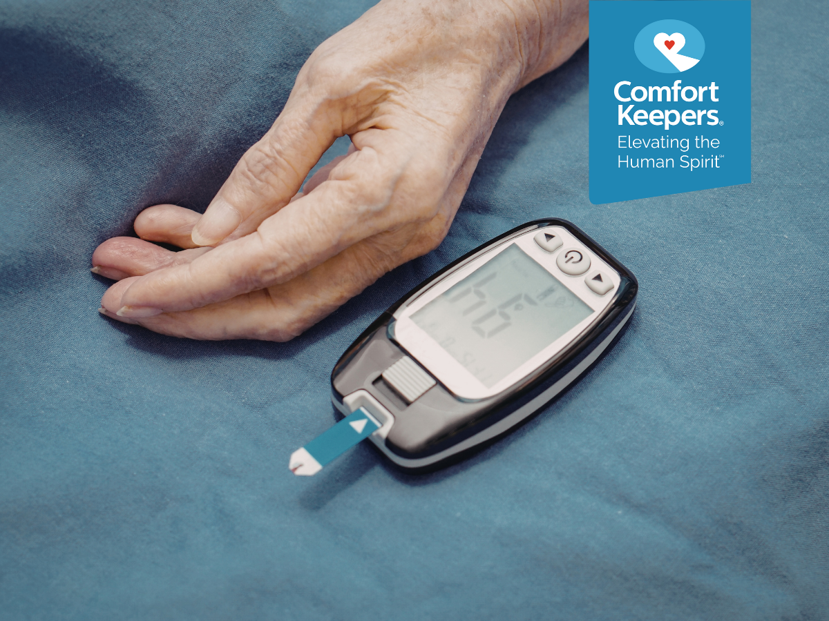 A senior hand lays next to a blood sugar monitor | Preventing Diabetes in British Columbia's Seniors | Comfort Keepers North and West Vancouver