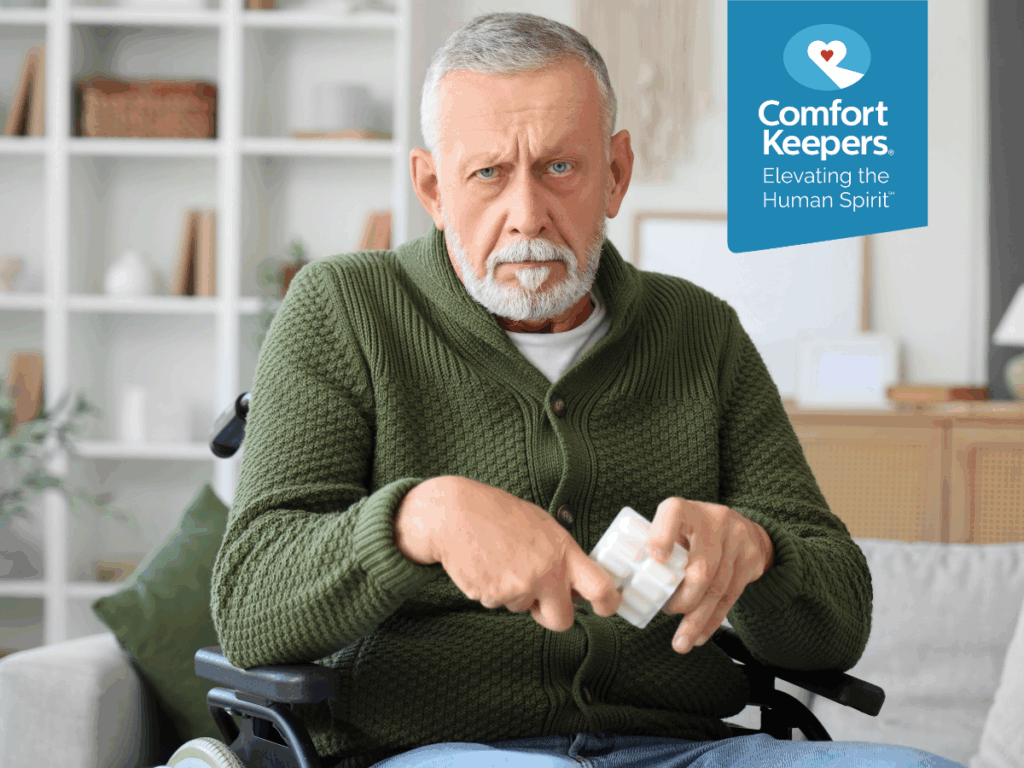 A senior male is seated on a couch | Promoting Bone Health | Comfort Keepers North and West Vancouver