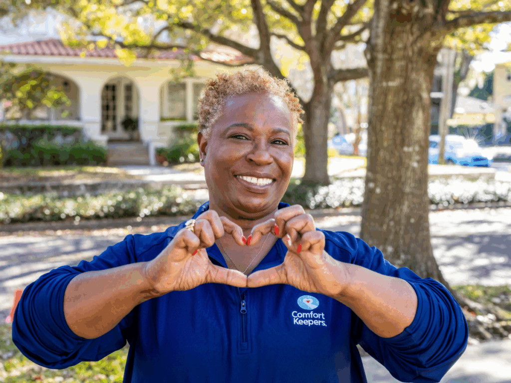 Comfort Keepers' caregiver smiling and making a heart with her hands | Choosing a Palliative Caregiver in North Vancouver | Comfort Keepers North and West Vancouver | BLOG POST
