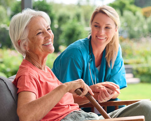Senior woman smiling while receiving compassionate in-home care from a professional caregiver, representing Parkinson’s support services in Ottawa and Kanata.