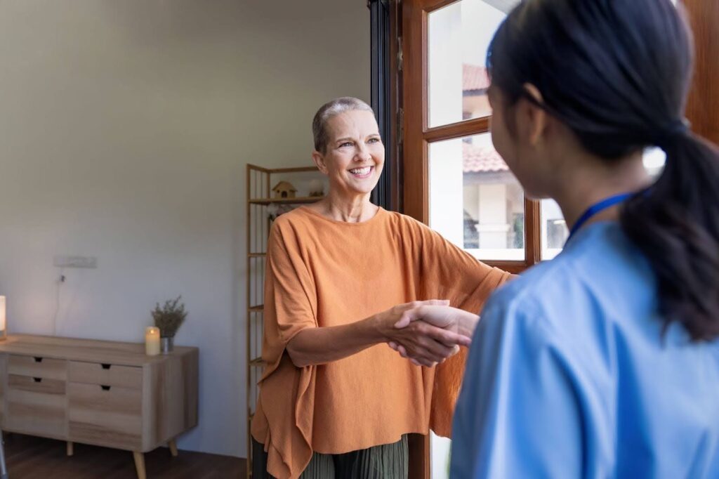 Caregiver visiting an elderly woman at home, providing companionship and professional support in Kanata.