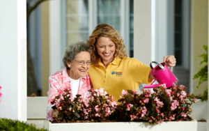 Katelyn and the senior client enjoyed watering the well-grown flowers.
