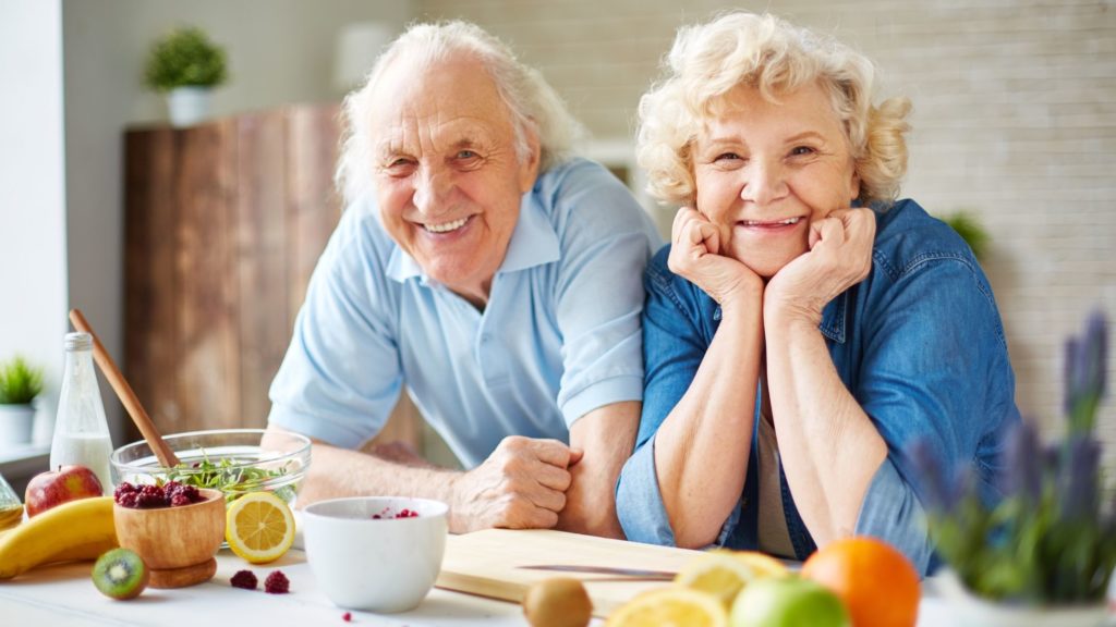Senior couple in kitchen preparing heart healthy food