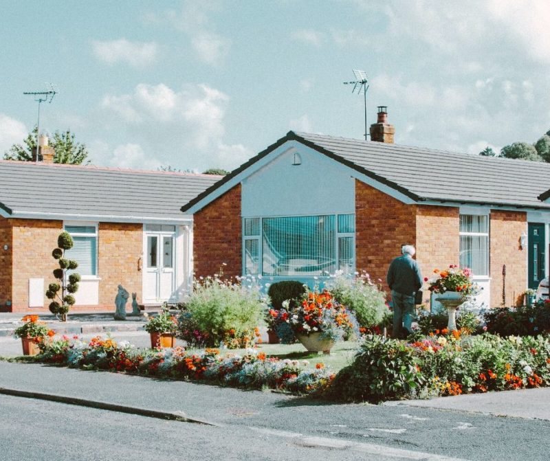 Senior man in front of his home