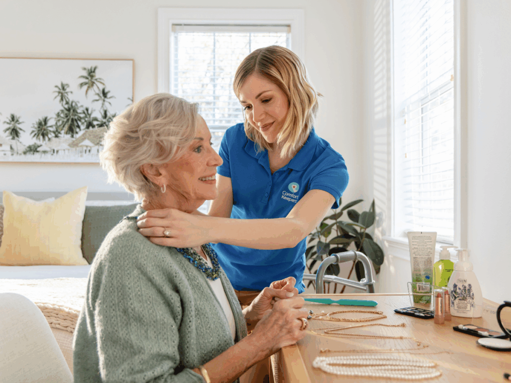 A senior woman being helped by a caregiver | What services are offered by Comfort Keepers Home Care Regina? | Comfort Keepers Regina | BLOG POST