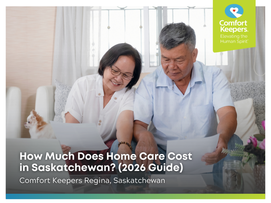 A senior couple goes over paperwork while sitting on the couch | How Much Does Home Care Cost in Saskatchewan (2026 Guide) | Comfort Keepers Regina