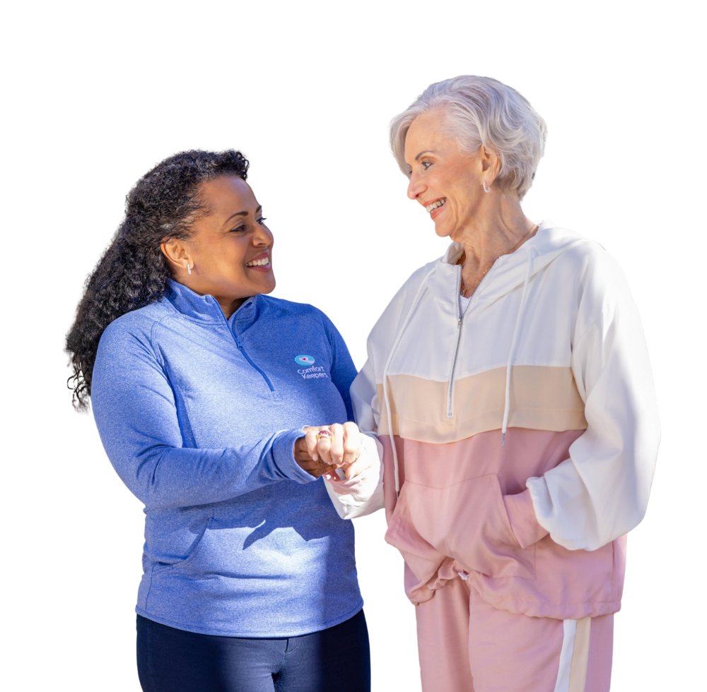 Comfort Keepers caregiver and client holding hands.