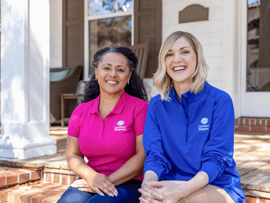 Two caregivers seated on a front porch | The Benefits of At-Home Dementia Care: A Comparative Guide for Tri-Cities Families | Comfort Keepers Tri-Cities | BLOG POST