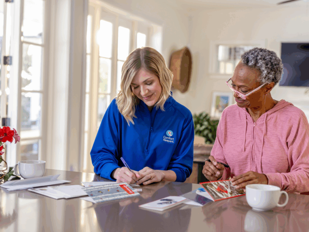 Caregiver working with senior client | Keeping Minds Bright: Simple Joys for Seniors at Home | Comfort Keepers Tri-Cities | BLOG POST