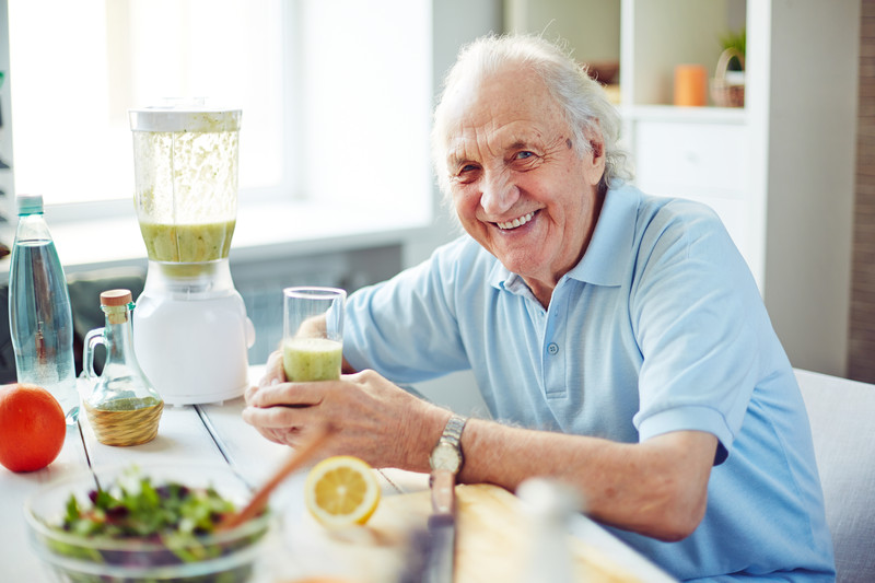 Senior male sitting in kitchen with a healthy smoothie | Healthier Diet | BLOG POST | Comfort Keepers Vancouver