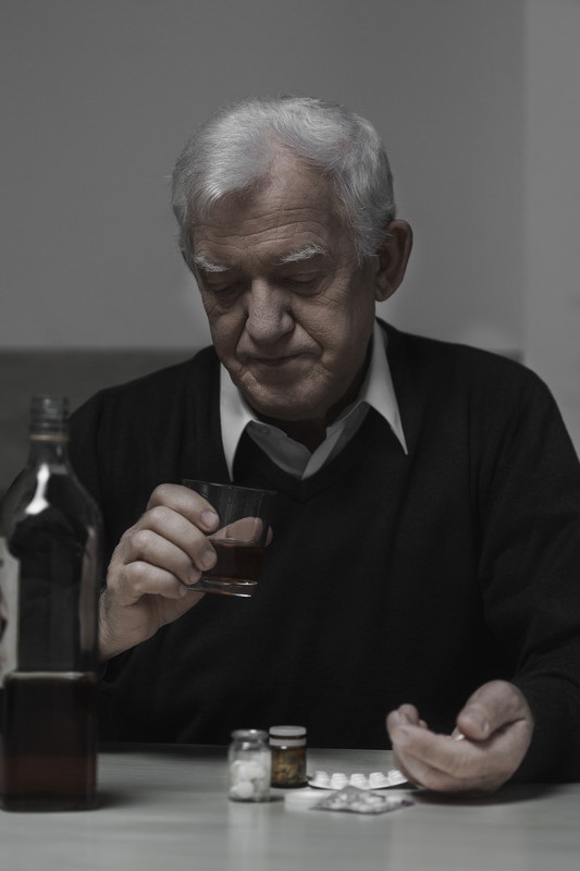 Senior male drinking at table | Alcohol Abuse | BLOG POST | Comfort Keepers Vancouver