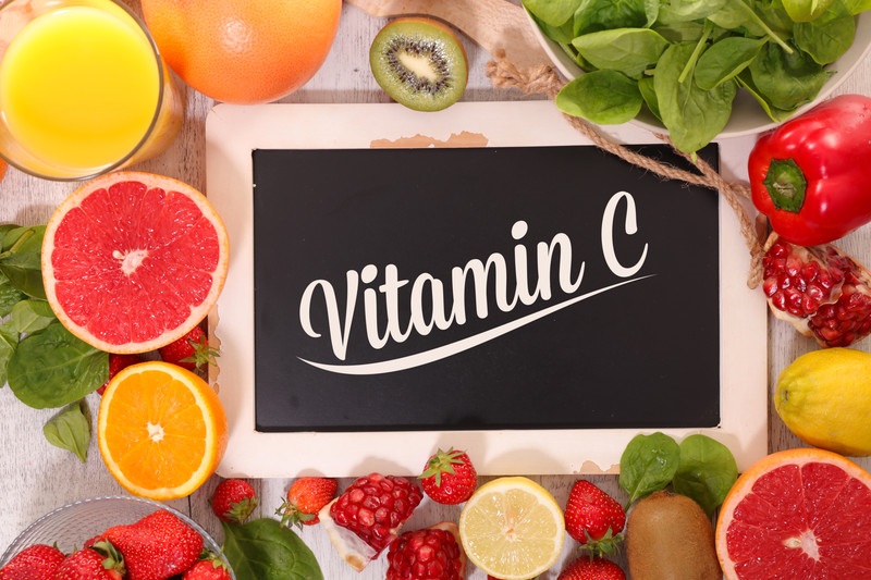 Photo of citrus fruits with a Vitamin C sign in the middle | Seniors and Vitamins | Comfort Keepers Vancouver | BLOG POST