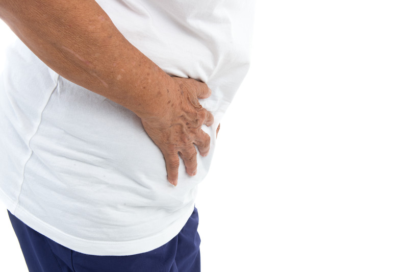 Individual holding stomach | Hernias and Seniors | BLOG POST | Comfort Keepers Vancouver