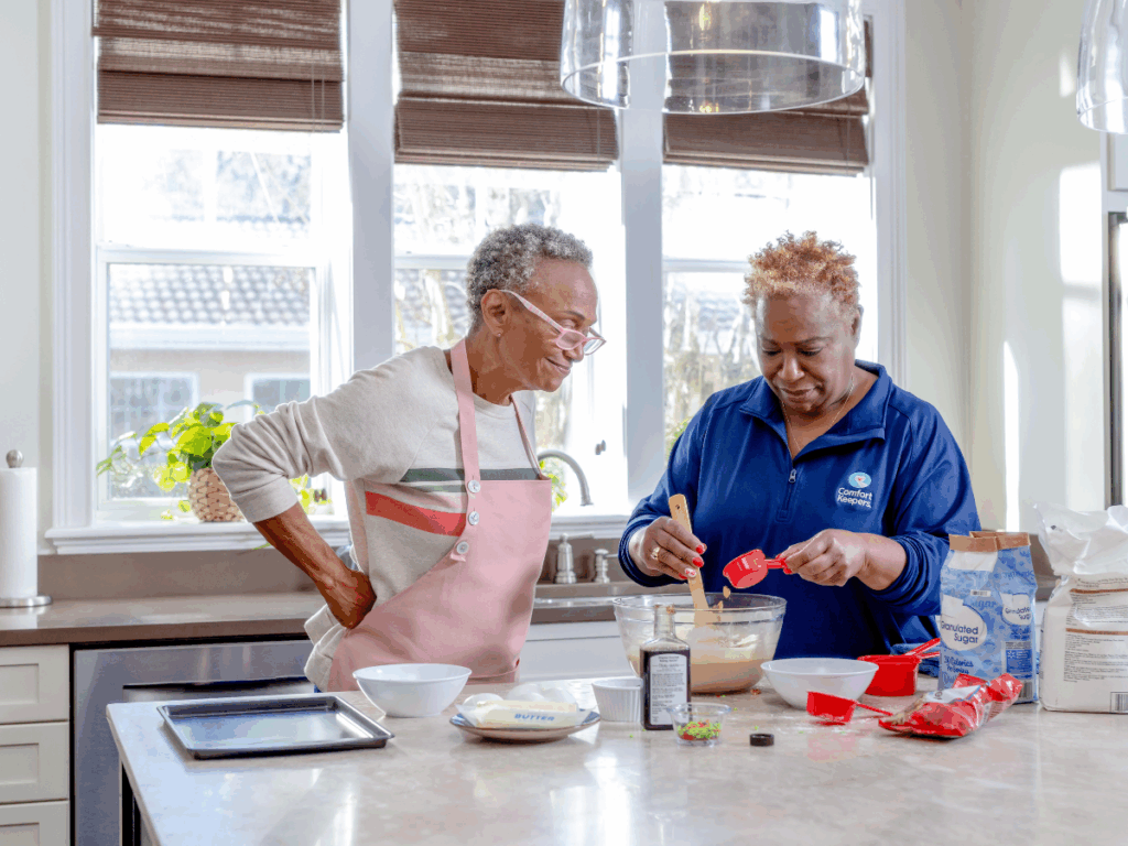 Senior woman and caregiver baking in the kitchen | Your Definitive Guide to Bathroom & Kitchen Upgrades for Aging in Place | Comfort Keepers Vancouver | BLOG POST
