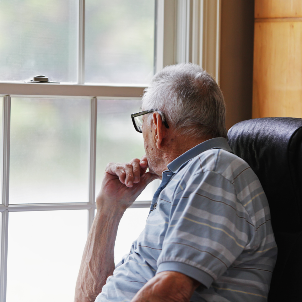 Senior male looking out a winter window | Accredited In-Home Care | BLOG POST | Comfort Keepers Victoria