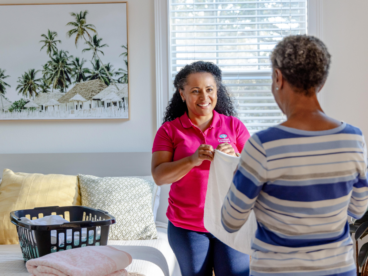 Senior folding laundry with her caregiver | Home Care Services for Seniors in Victoria, BC | Comfort Keepers Victoria