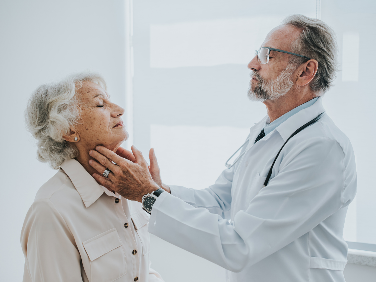 A doctor checks a senior's thyroid | A Short Guide to Thyroid Disease for Victoria's Seniors | Comfort Keepers Victoria