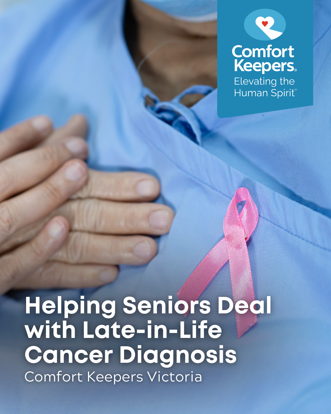 Senior in hospital scrubs adorned with a pink breast cancer ribbon | Helping Seniors Deal With Late-in-Life Cancer Diagnosis | Comfort Keepers Victoria |