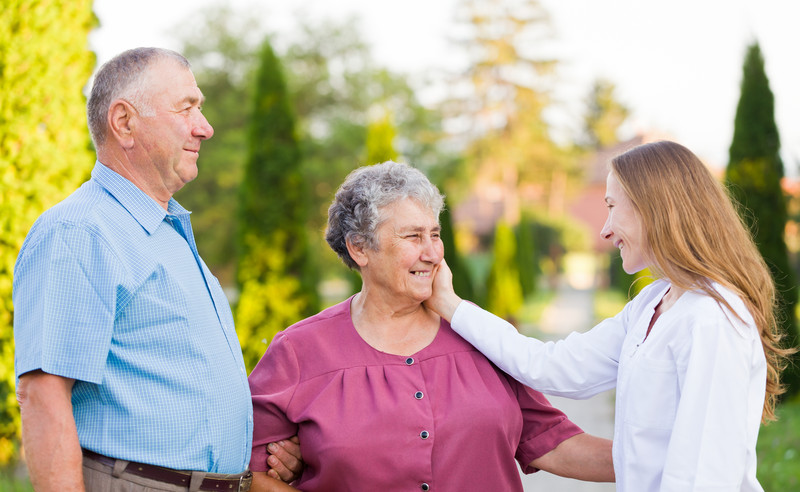 Pair of Seniors with Caregiver. Caregiver touching client's face | Cancer Prevention | BLOG POST | Comfort Keepers Victoria