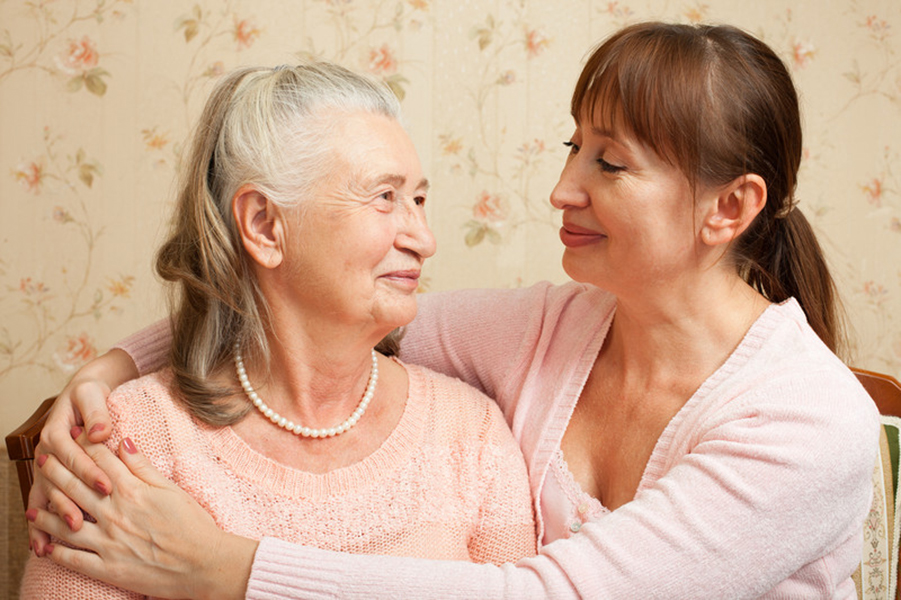 Senior and Caregiver embraced and smiling | Benefits of Choosing a 24-Hour Home Care | Comfort Keepers Victoria | BLOG POST