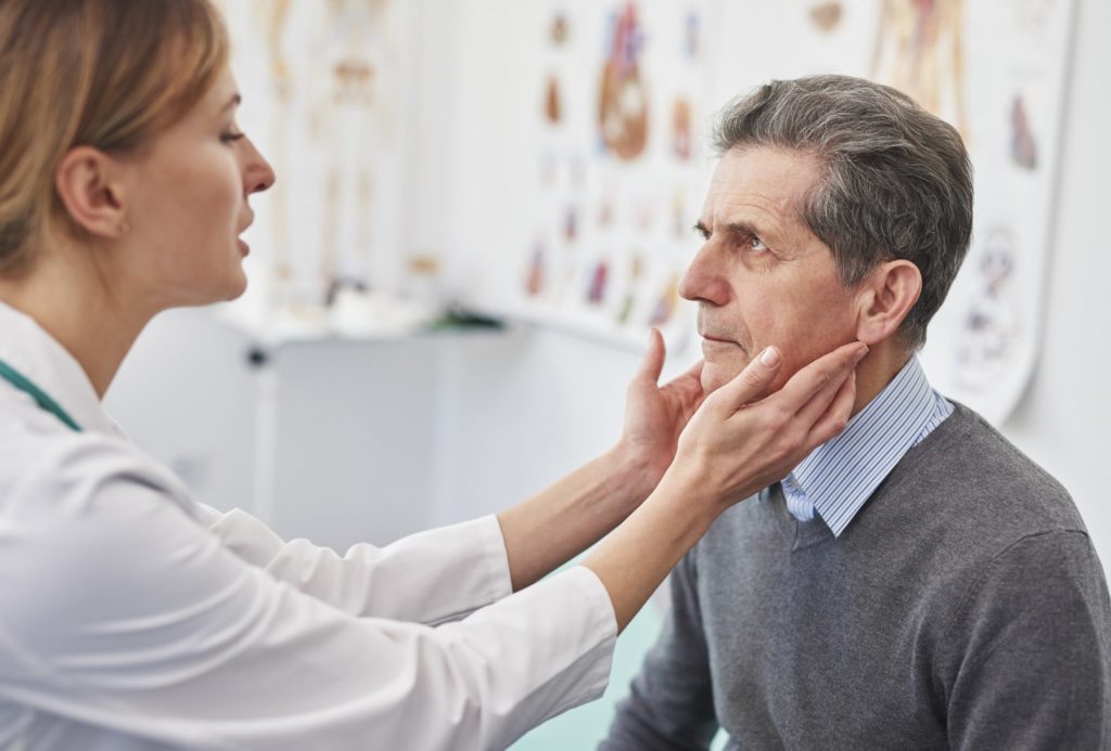 Physician with senior patient | Thyroid Disease in Seniors | BLOG POST | Comfort Keepers Victoria