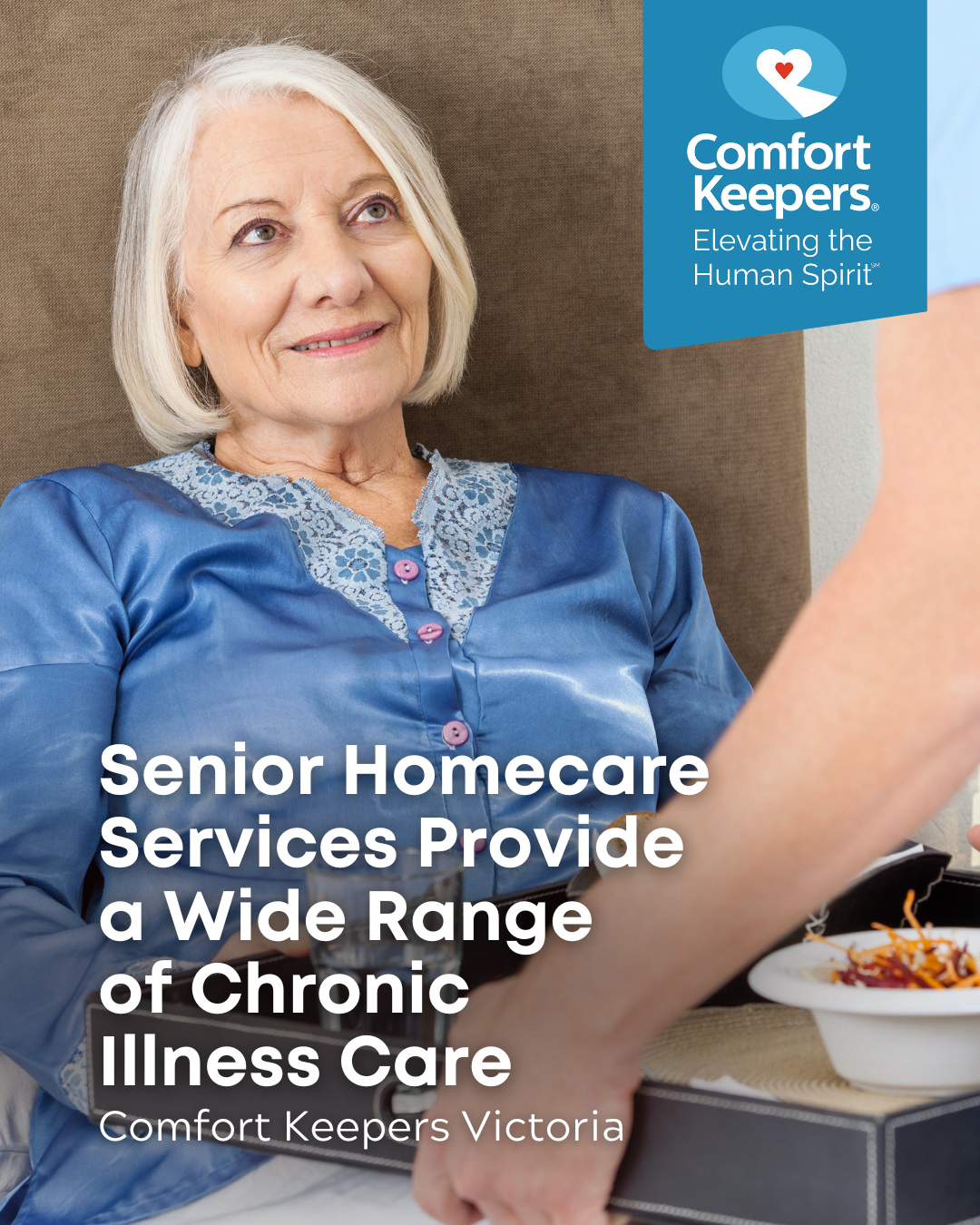 Senior woman in bed while caregiver serves her a tray | Senior Homecare Services Provide a Wide Range of Chronic Illness Care | Comfort Keepers Victoria | BLOG POST